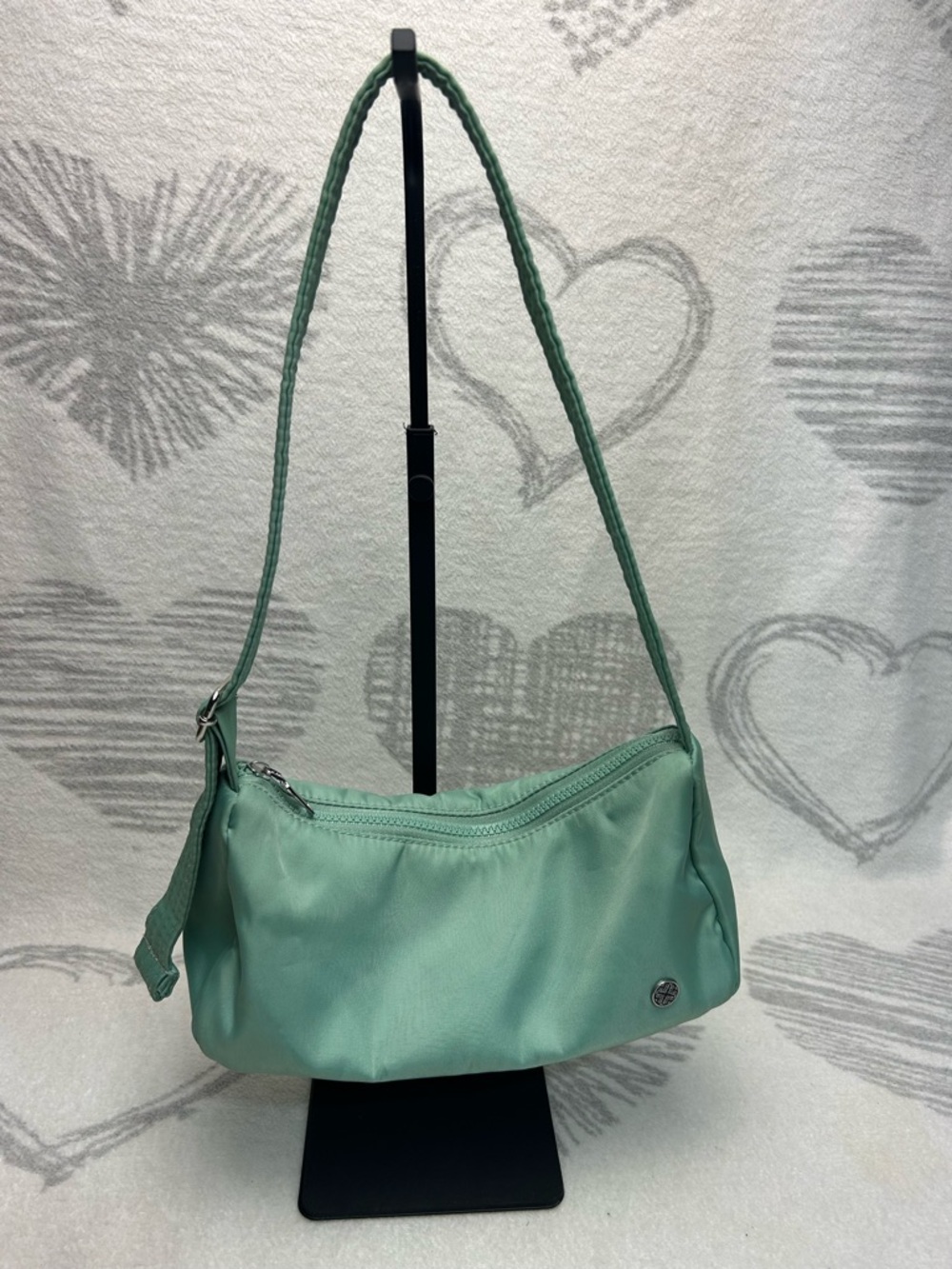Mini green shoulder bag. Has a adjustable strap and clean interior